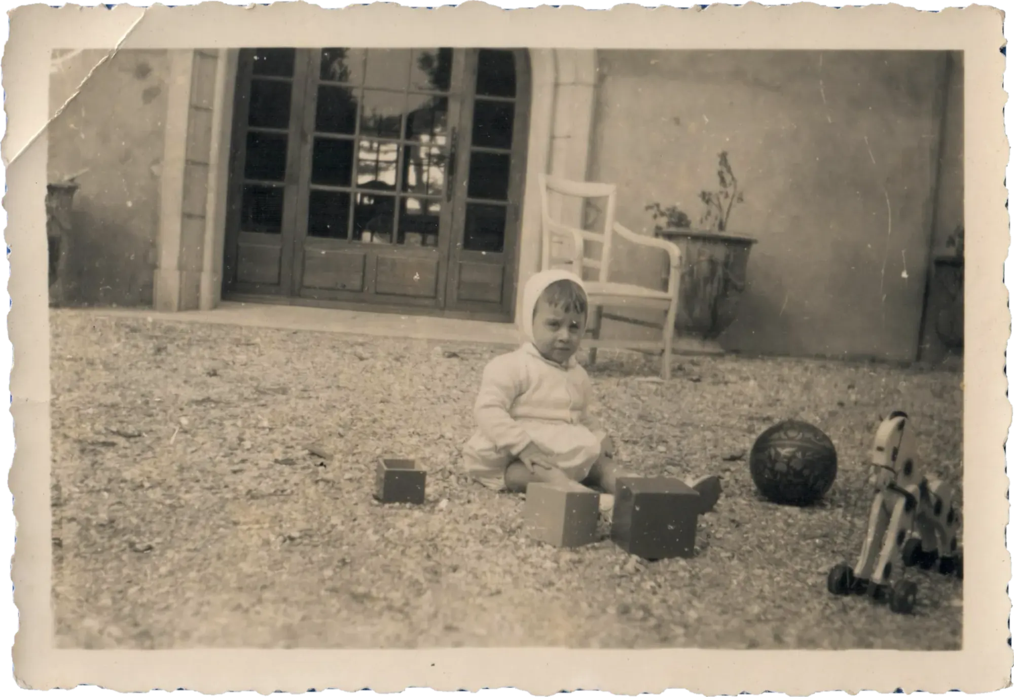 Édouard and his toys in front of the sheepfold, 1950s