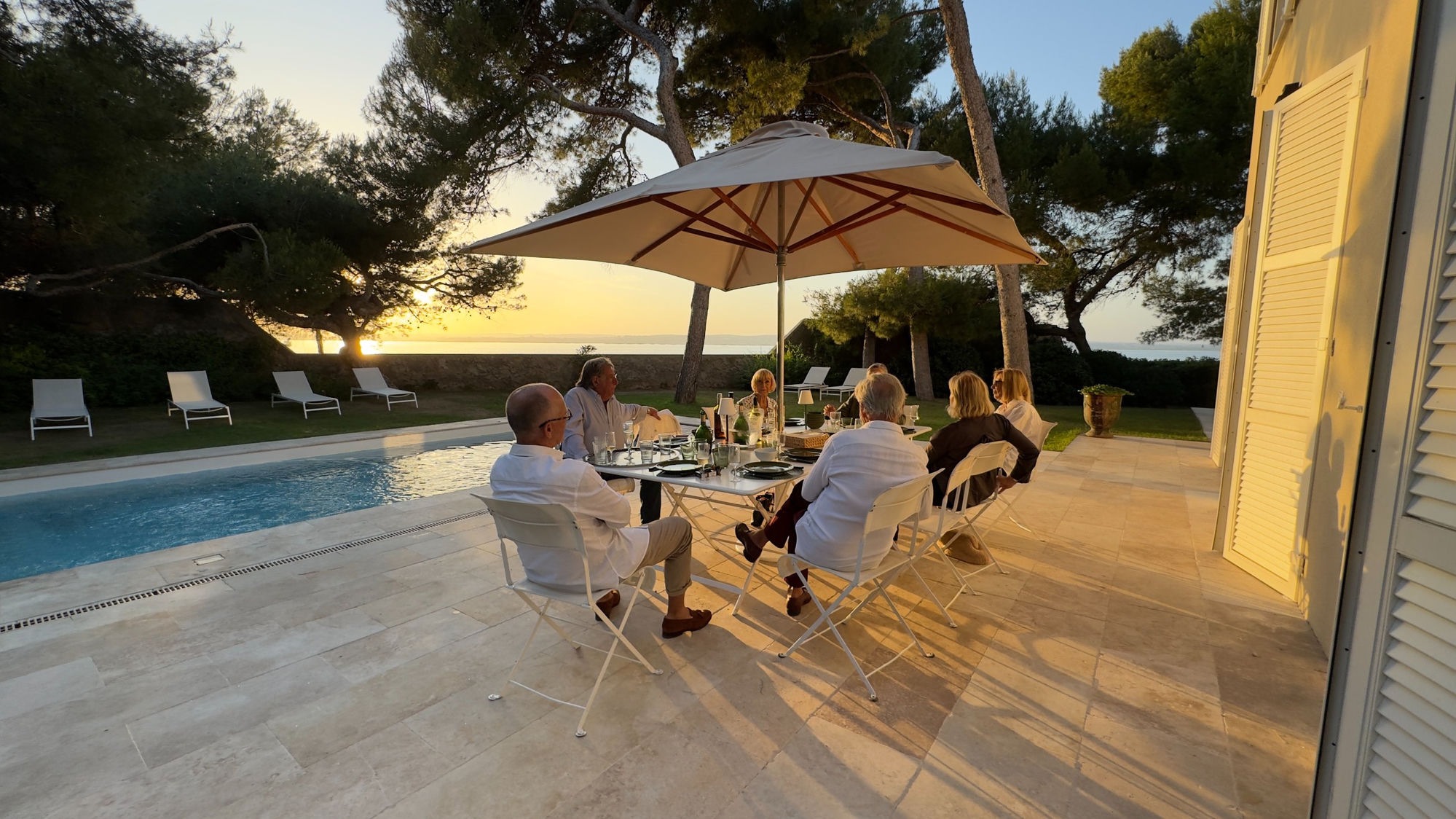 Dinner with friends on the terrace, at sunset over the lagoon