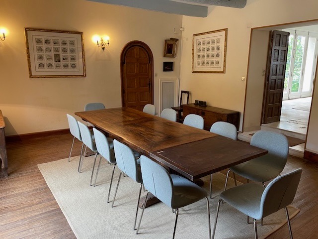 The connecting sitting room set up as a working table, beneath the beams